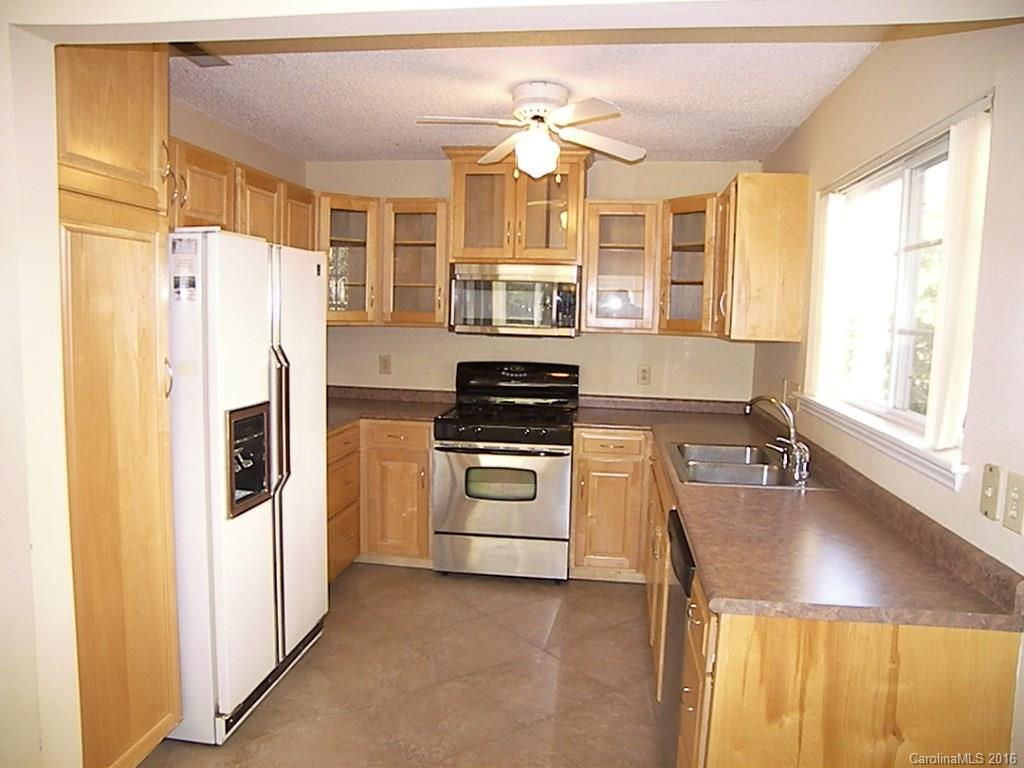 9913 Fairway Ridge Road Charlotte, NC 28277 - Photo 10 of 18 a kitchen with a refrigerator and a stove