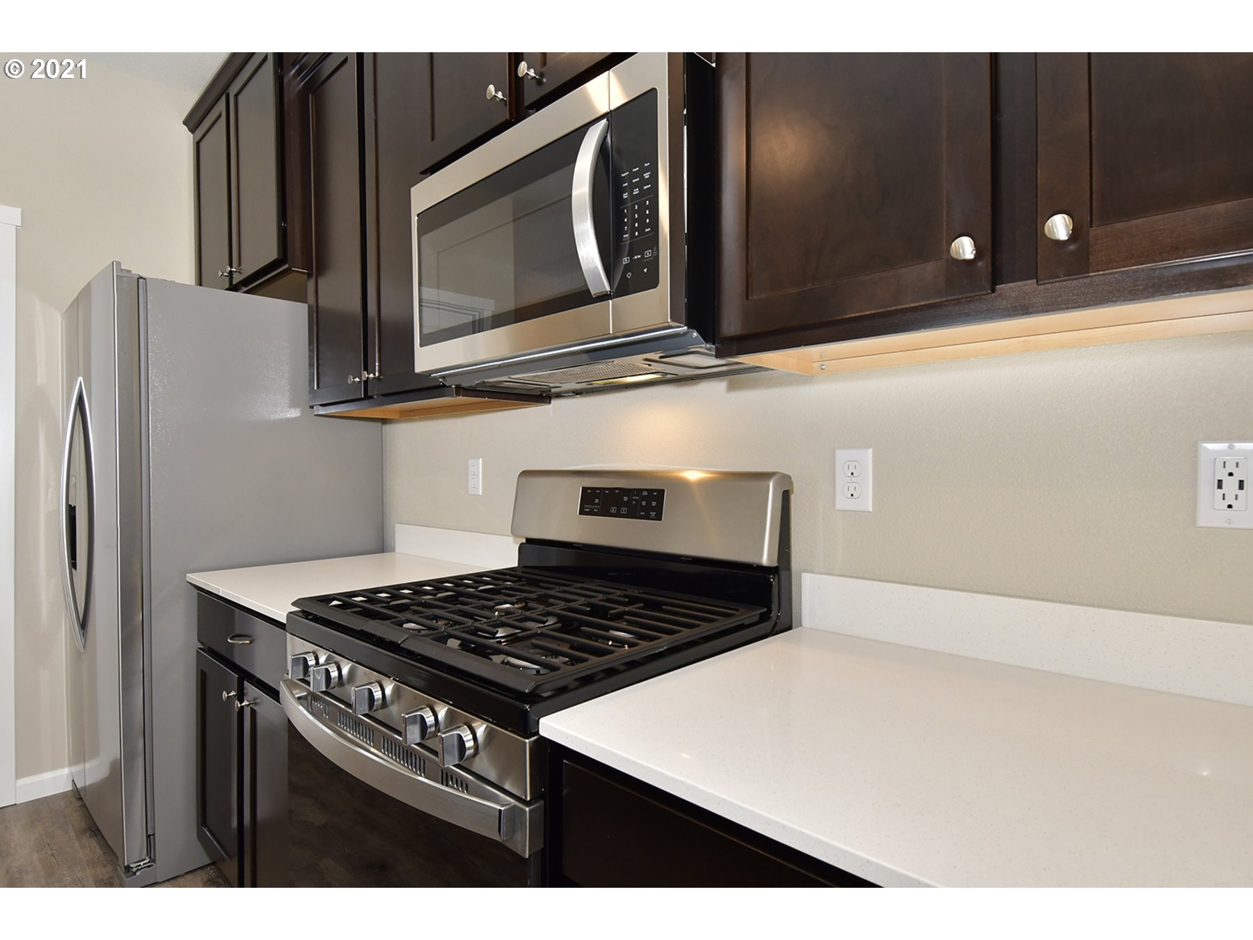 7011 Northeast 156th Place Vancouver, WA 98682 - Photo 2 of 21 a kitchen with stainless steel appliances granite countertop a stove a microwave and cabinets