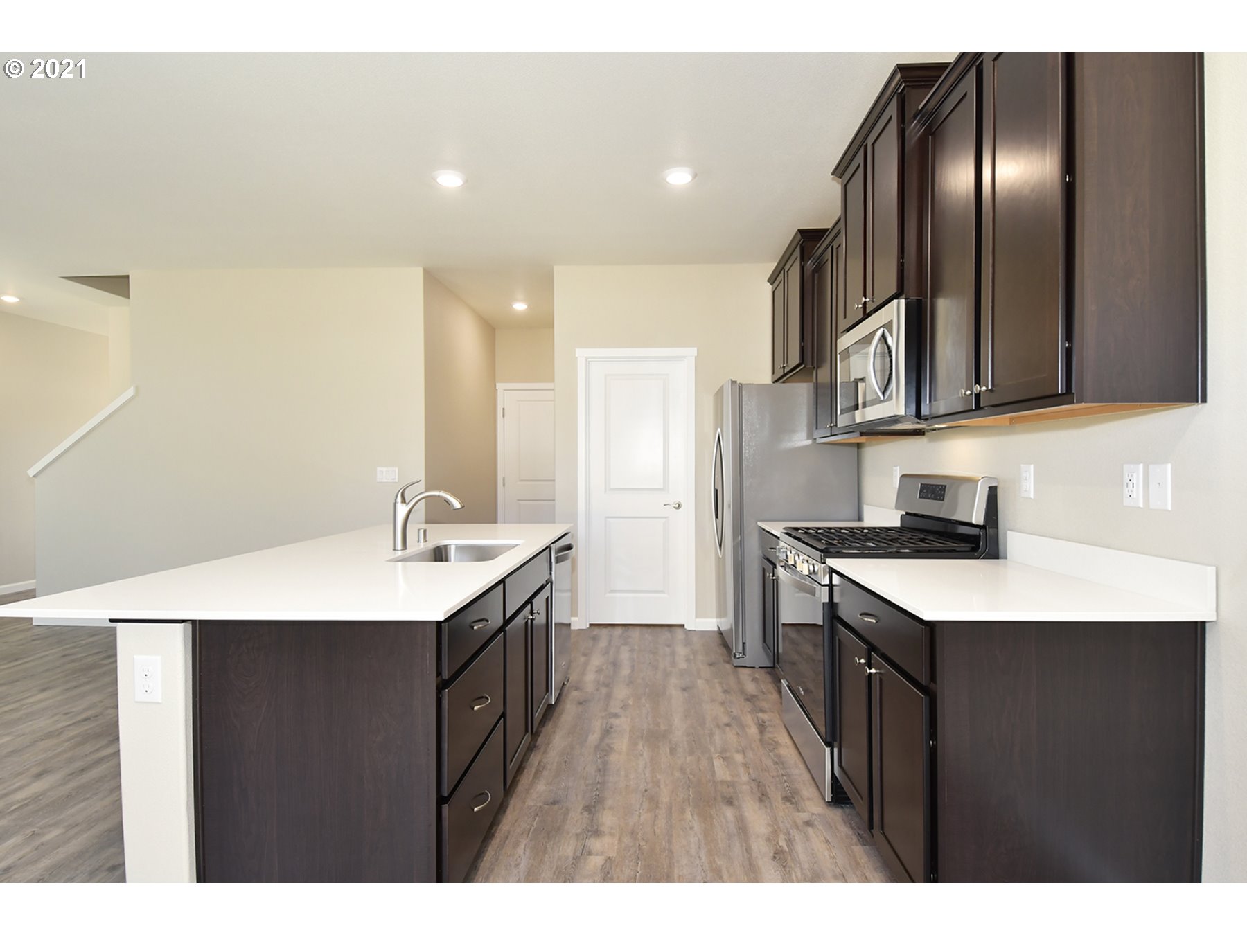 7011 Northeast 156th Place Vancouver, WA 98682 - Photo 3 of 21 a kitchen with a sink stove and cabinets