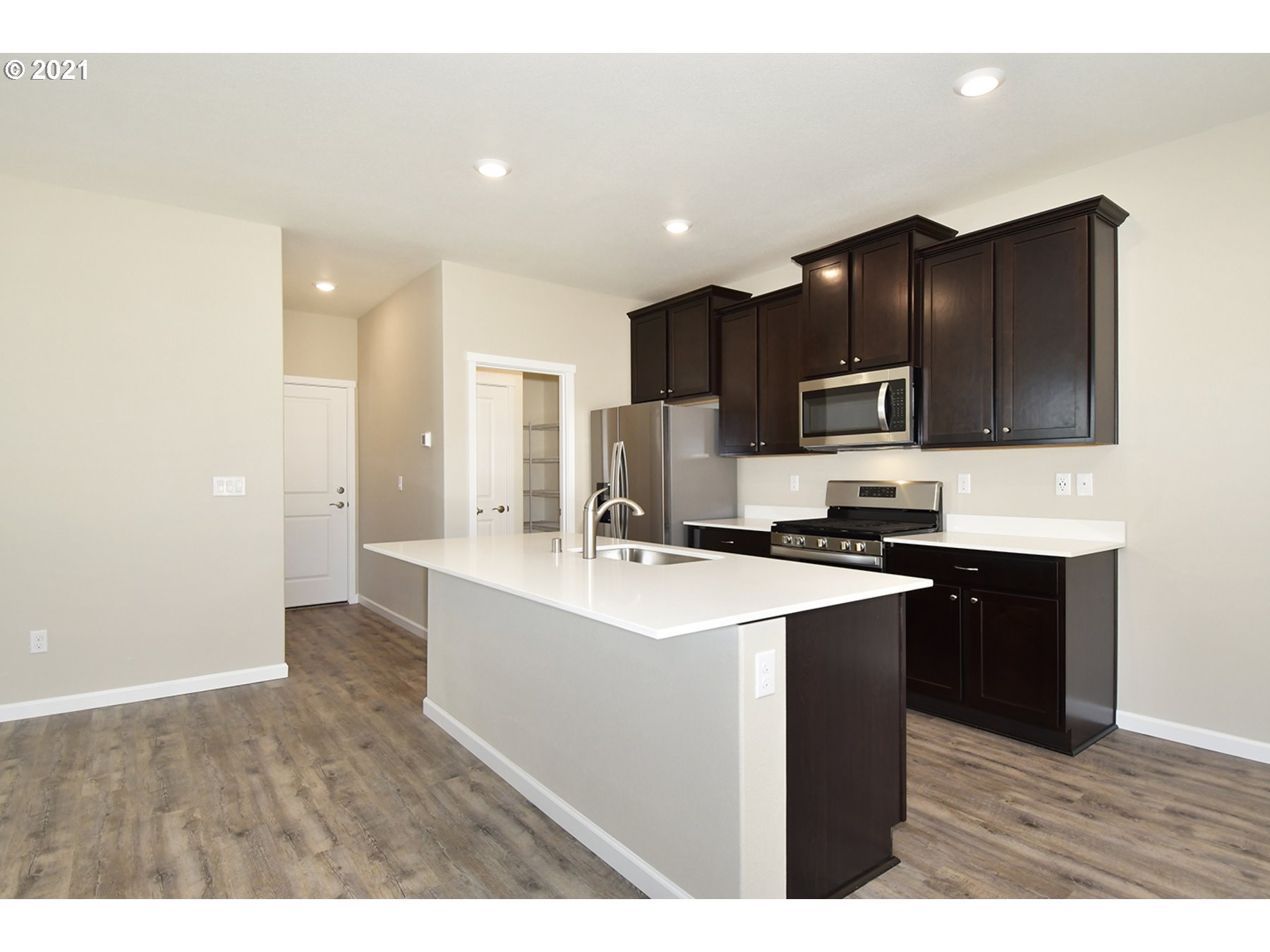 7011 Northeast 156th Place Vancouver, WA 98682 - Photo 4 of 21 a kitchen with kitchen island a sink stainless steel appliances and cabinets