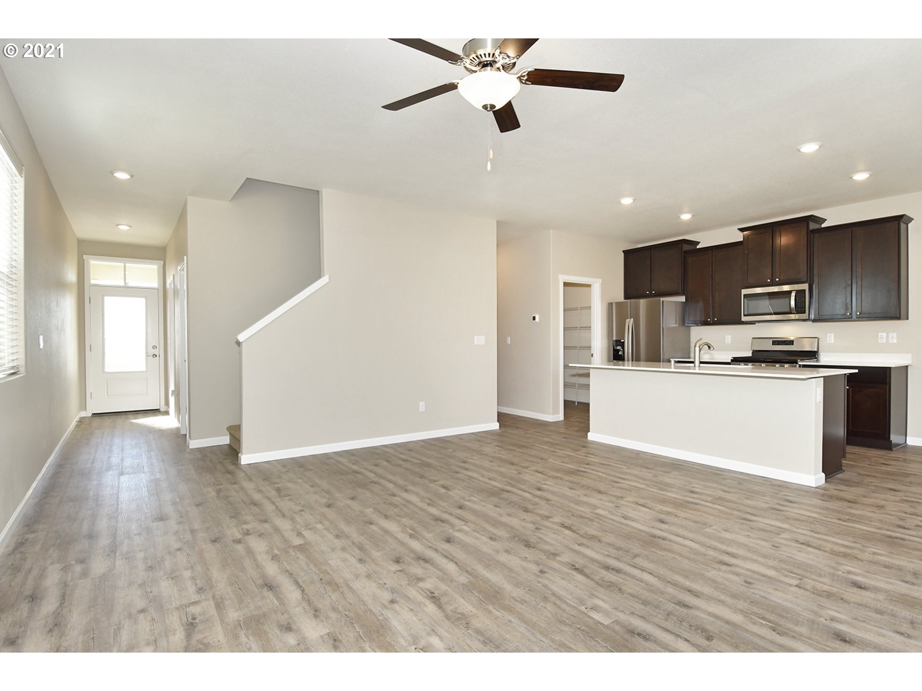 7011 Northeast 156th Place Vancouver, WA 98682 - Photo 6 of 21 a view of kitchen with refrigerator microwave and stove