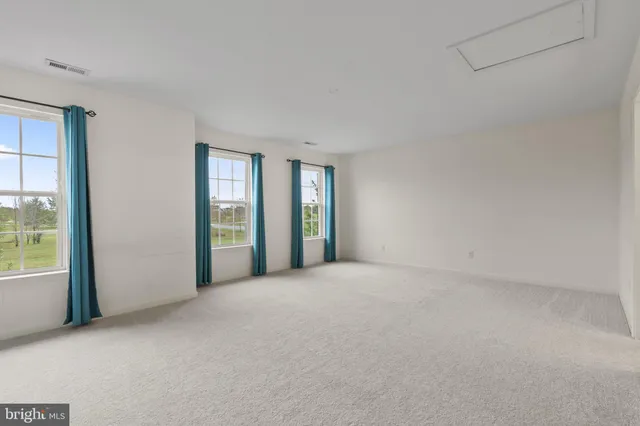 a view of a lake with houses in back