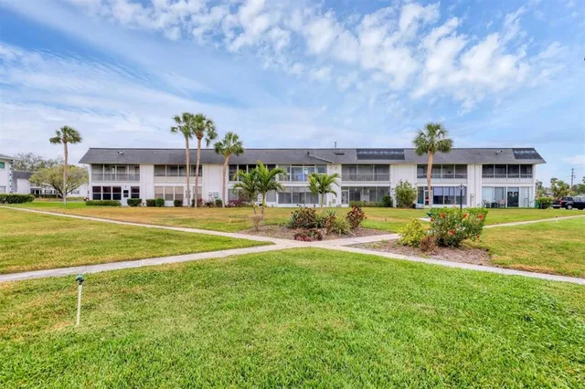 a view of a chairs and table in the back yard of the house