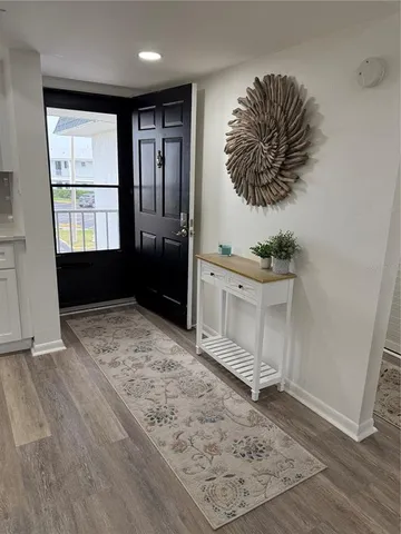 an empty room with a cabinet and a rug