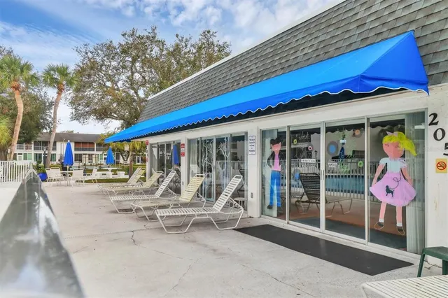 a view of a house with backyard sitting area and a garden