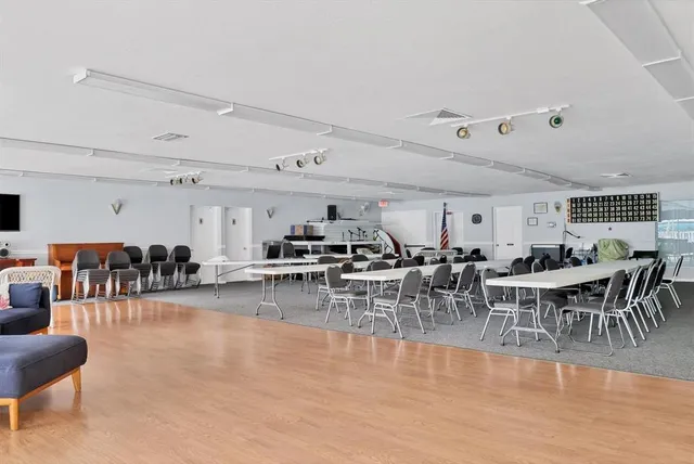 a view of building with cars parked