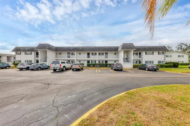 a view of a cars park in front of a building