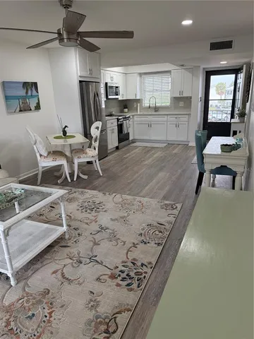 a living room with hard wood flooring and furniture