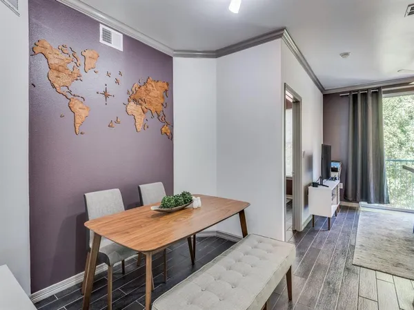 a living room with furniture and a dining table