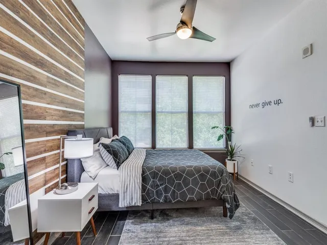 a bedroom with a large bed and a window