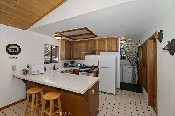 a kitchen with a sink a refrigerator and a stove