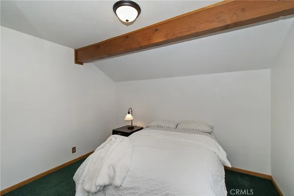 a bedroom with a bed and chair
