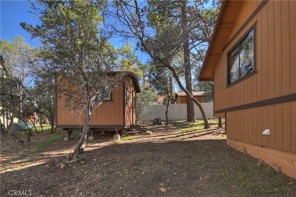 a view of a house with a yard and tree