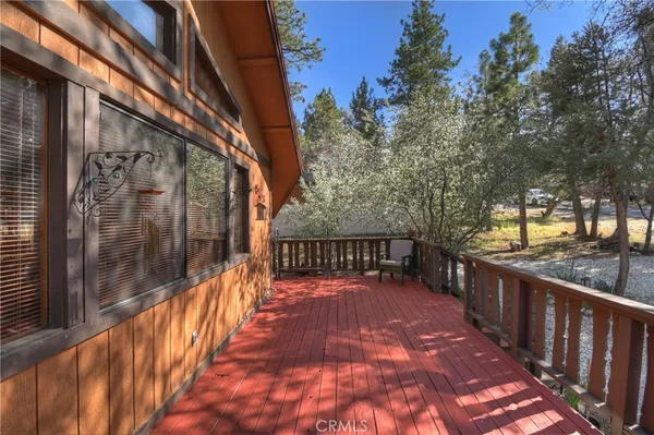 a view of balcony with wooden floor and fence