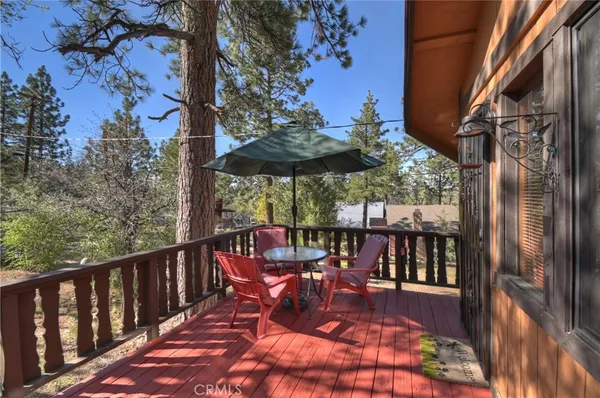 a view of balcony with furniture and umbrella