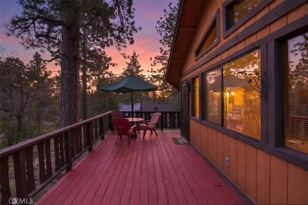 a view of balcony with furniture and wooden floor