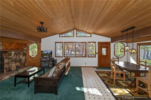 a living room with furniture a window and flat screen tv