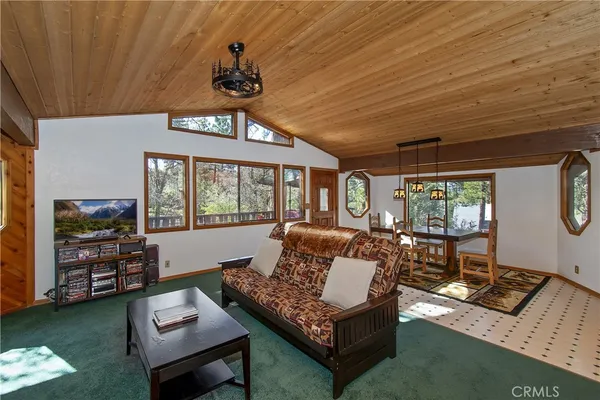 a living room with furniture a window and a flat screen tv