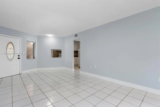 a view of an empty room and wooden floor