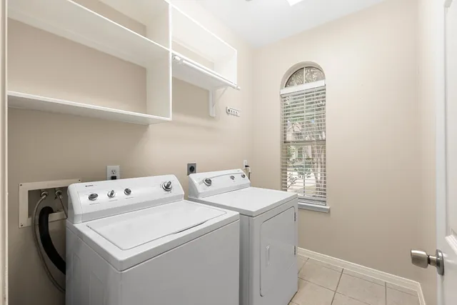 a large kitchen with granite countertop a sink stainless steel appliances and cabinets