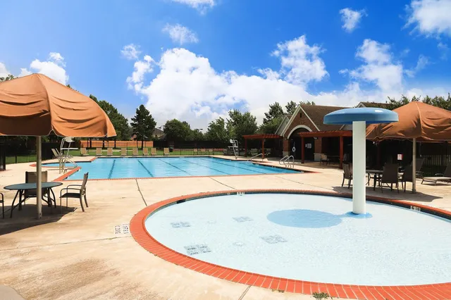 a view of a house with backyard and a tree