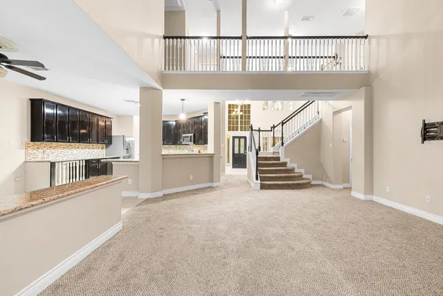 a view of staircase with railing and a chandelier