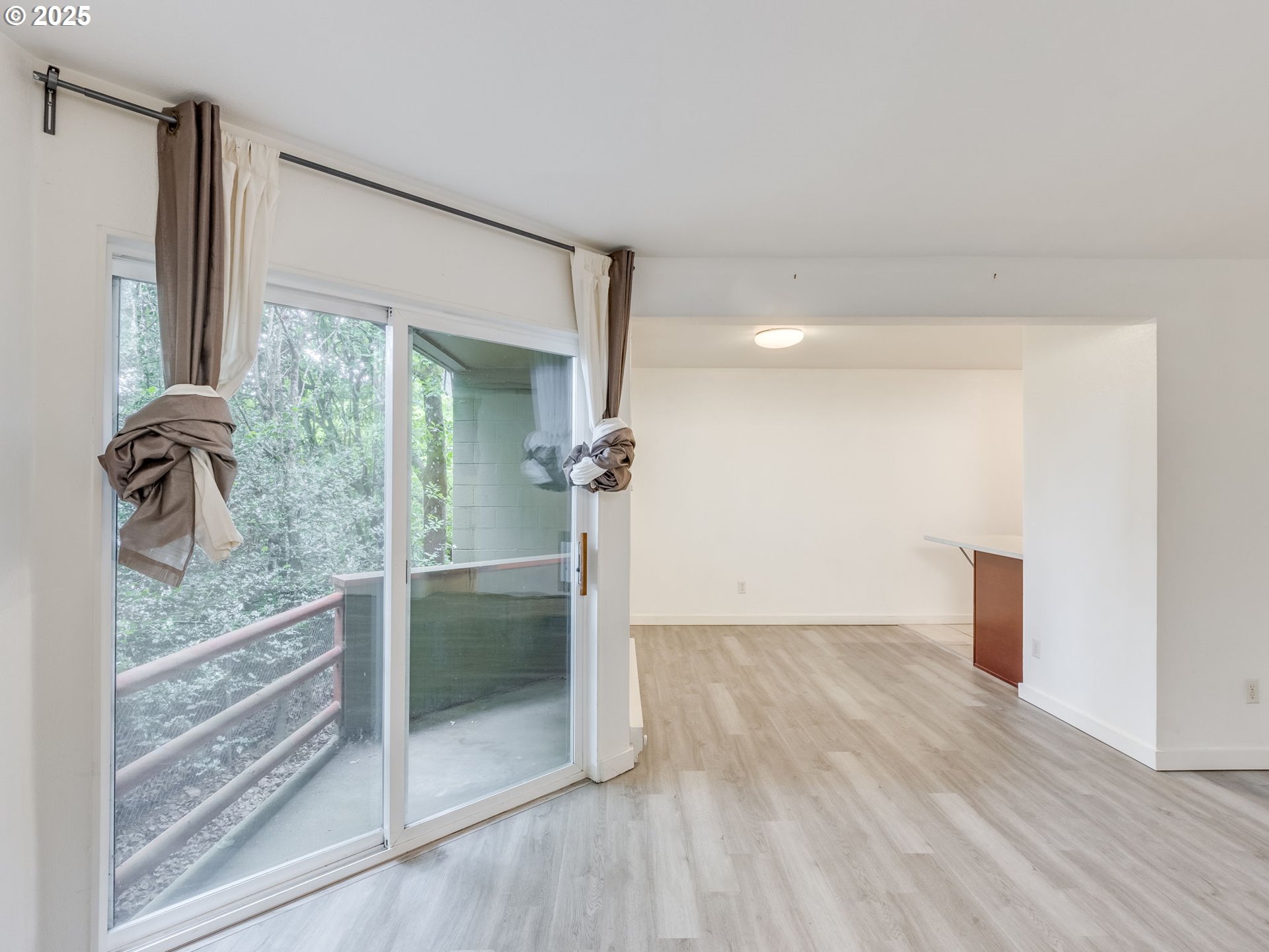 6220 Southwest Capitol Highway, Unit 7 Portland, OR 97239 - Photo 12 of 31 a view of a livingroom with wooden floor and a bathroom