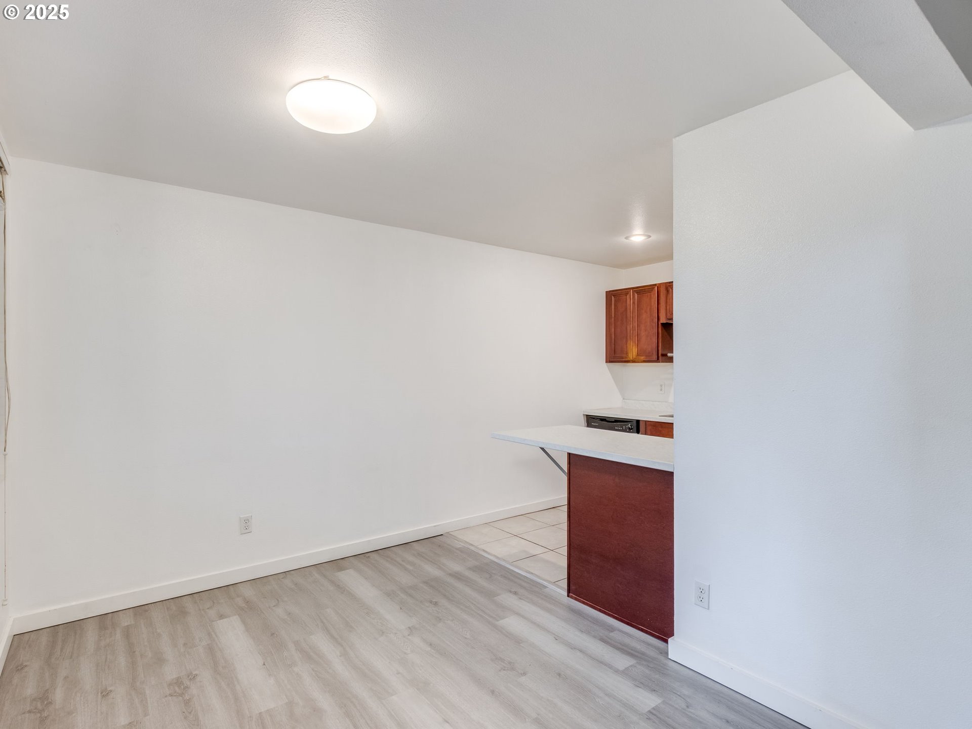 6220 Southwest Capitol Highway, Unit 7 Portland, OR 97239 - Photo 15 of 31 a view of a kitchen with wooden floor and electronic appliances