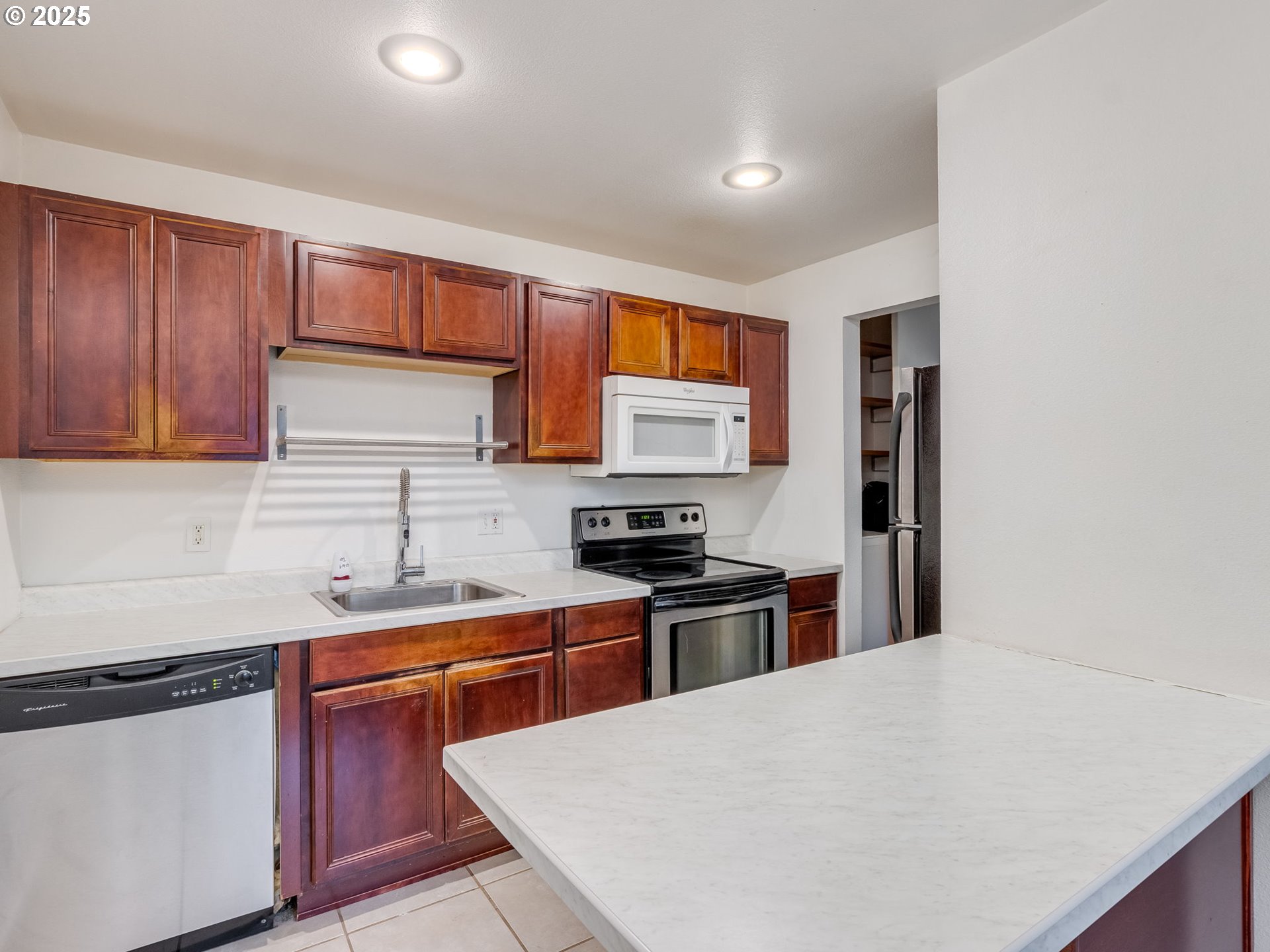 6220 Southwest Capitol Highway, Unit 7 Portland, OR 97239 - Photo 19 of 31 a kitchen with stainless steel appliances a sink stove and cabinets