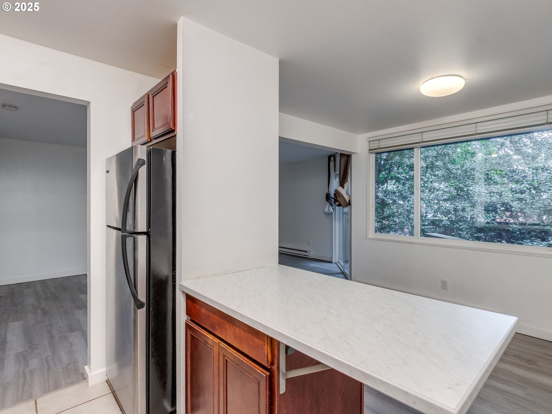 6220 Southwest Capitol Highway, Unit 7 Portland, OR 97239 - Photo 22 of 31 a view of kitchen with refrigerator windows and wooden floor