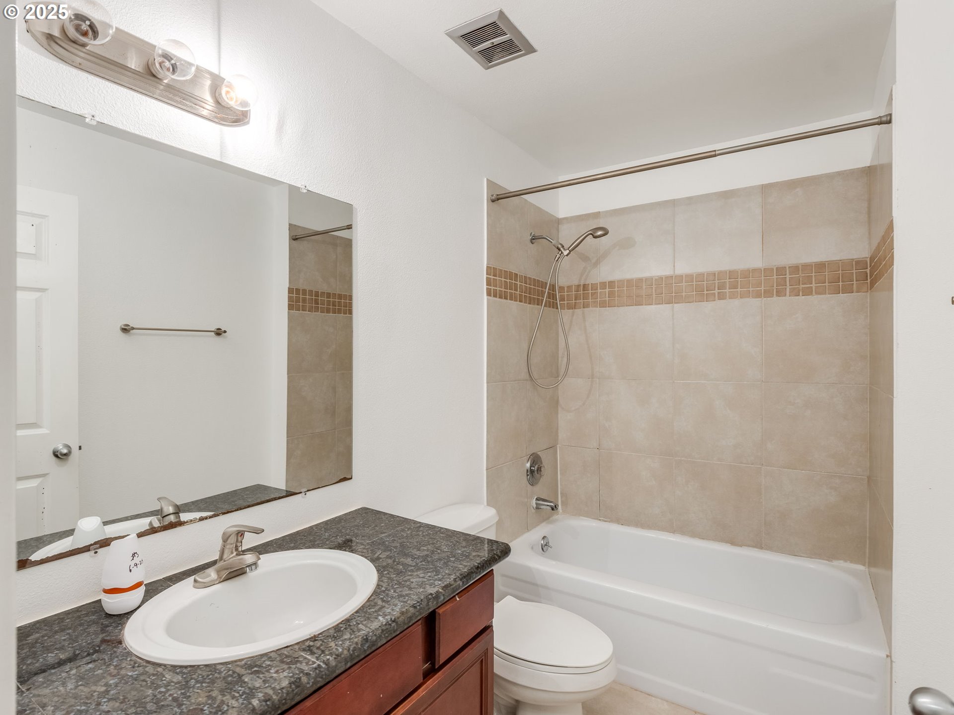 6220 Southwest Capitol Highway, Unit 7 Portland, OR 97239 - Photo 24 of 31 a bathroom with a granite countertop sink mirror toilet and bathtub