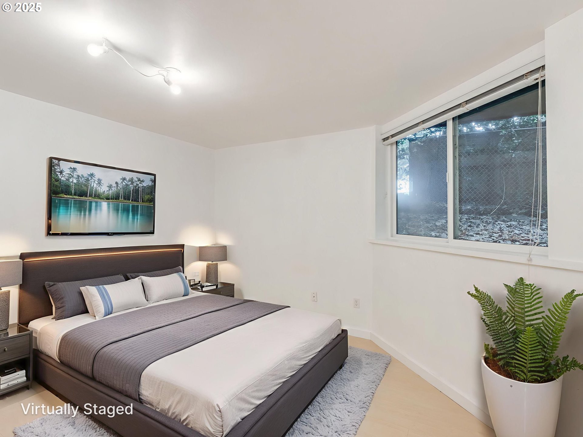6220 Southwest Capitol Highway, Unit 7 Portland, OR 97239 - Photo 27 of 31 a bedroom with a bed and a painting on the wall