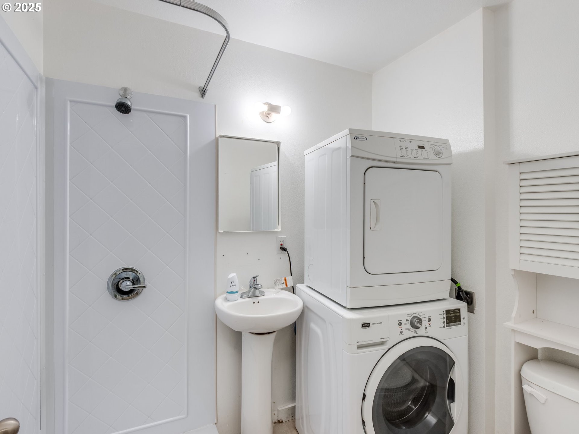 6220 Southwest Capitol Highway, Unit 7 Portland, OR 97239 - Photo 4 of 31 a bathroom with a sink a mirror and shower