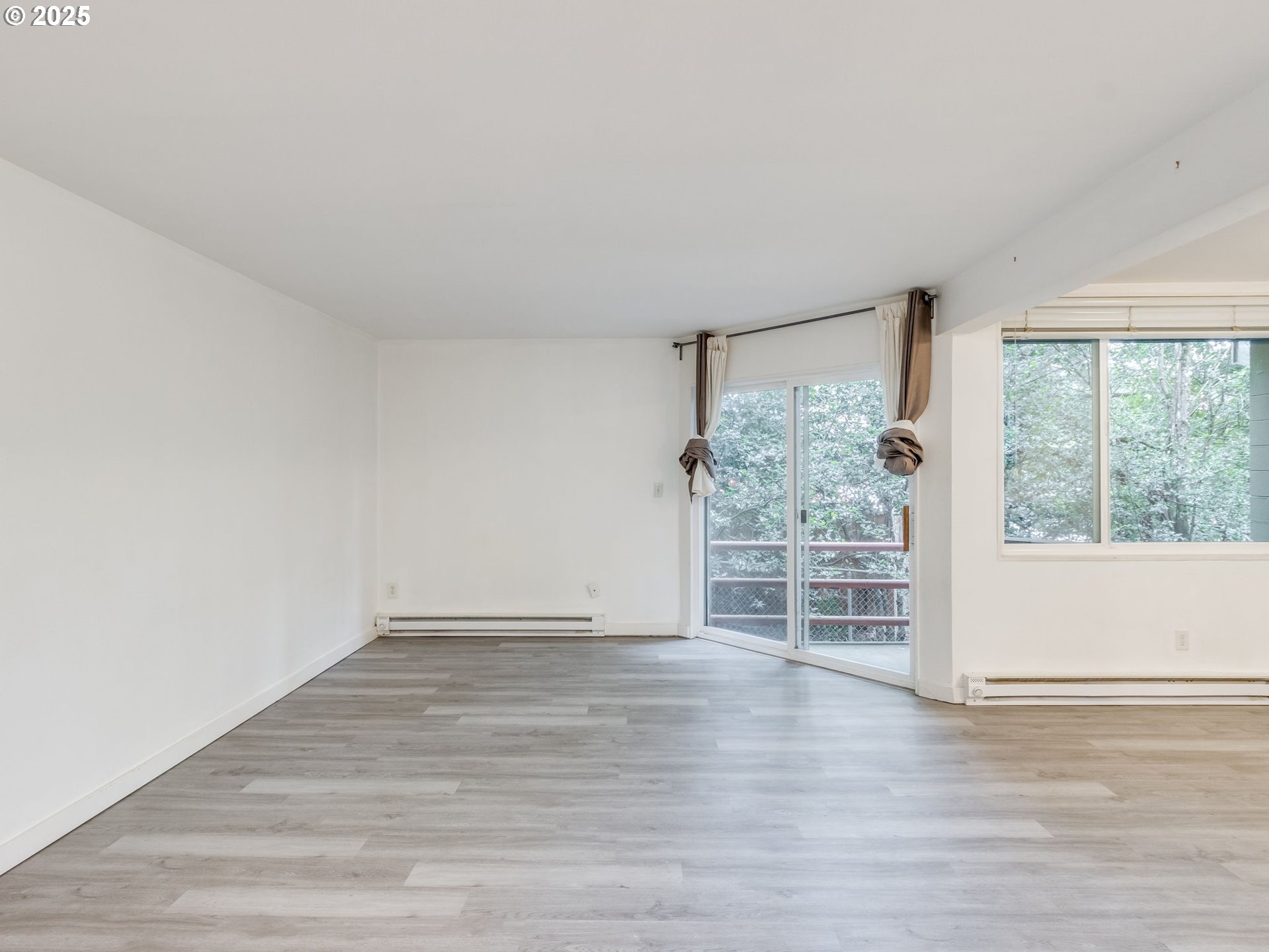6220 Southwest Capitol Highway, Unit 7 Portland, OR 97239 - Photo 6 of 31 wooden floor in an empty room with a window