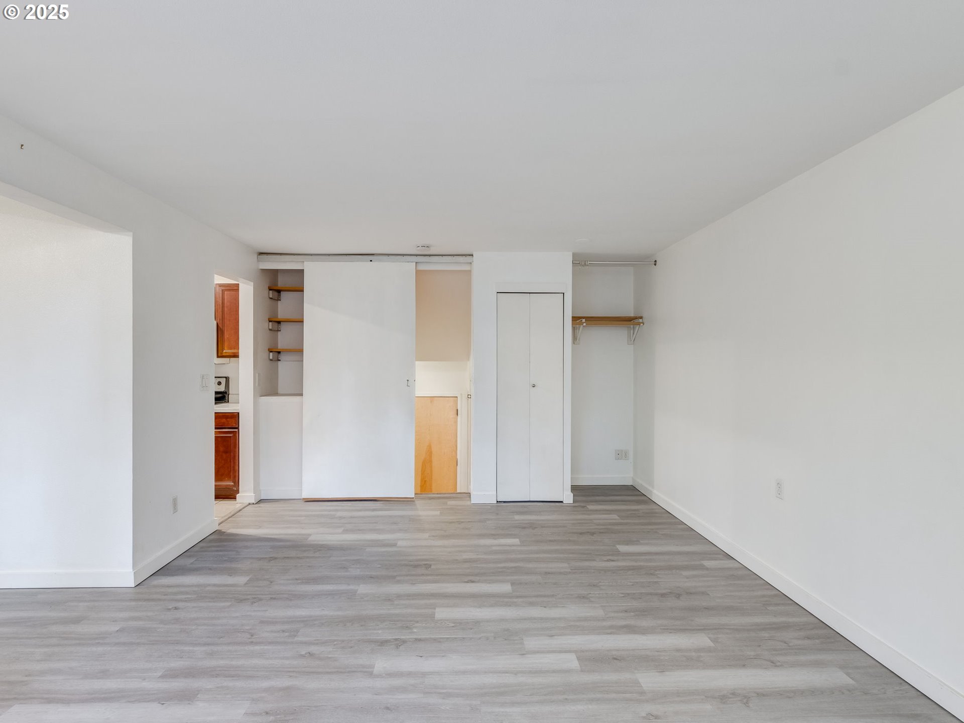 6220 Southwest Capitol Highway, Unit 7 Portland, OR 97239 - Photo 10 of 31 a view of an empty room with wooden floor