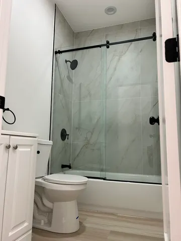 a bathroom with a toilet and a shower