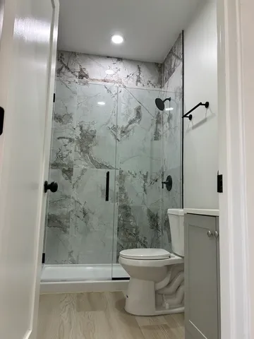 a bathroom with a shower and a toilet