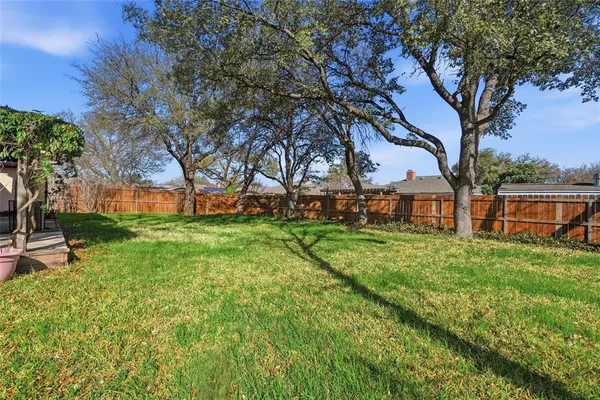 a view of yard with swimming pool and green space