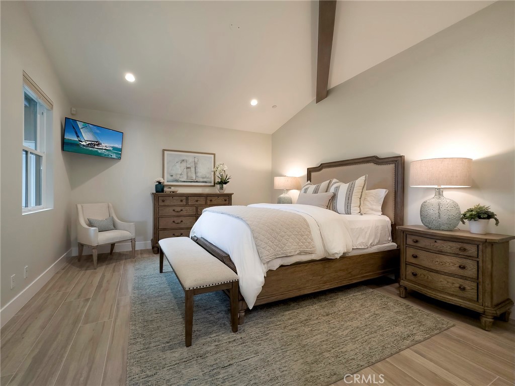 33971 Nauticus Isle Dana Point, CA 92629 - Photo 16 of 27 a bedroom with a bed and a lamp