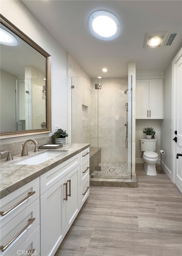 33971 Nauticus Isle Dana Point, CA 92629 - Photo 18 of 27 a bathroom with a double vanity sink a toilet and a shower