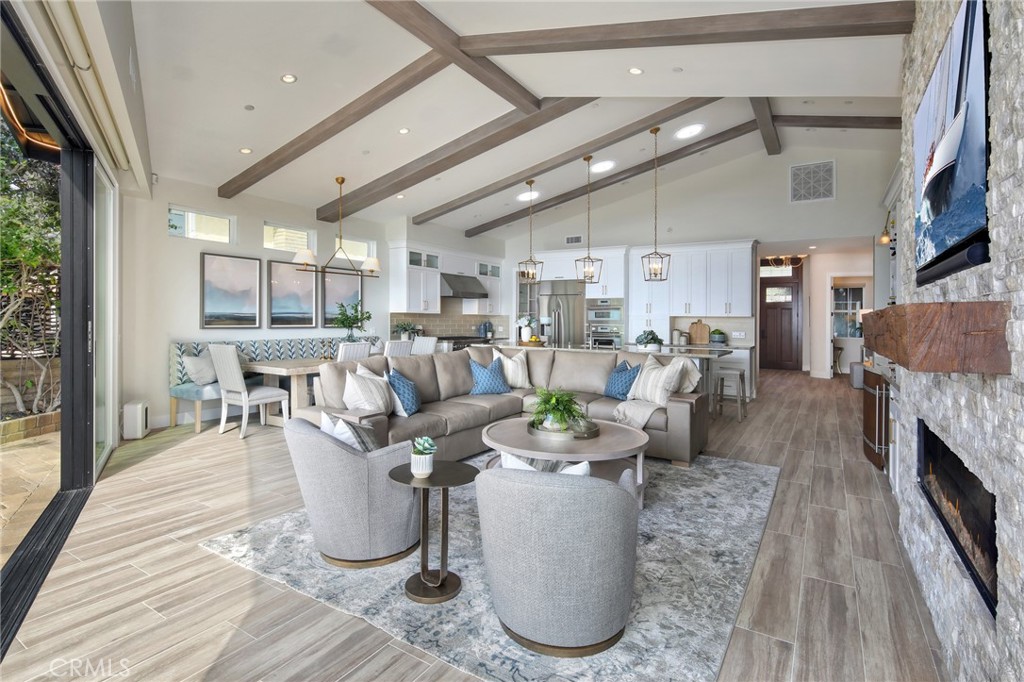 33971 Nauticus Isle Dana Point, CA 92629 - Photo 3 of 27 a living room with lots of furniture and a fireplace