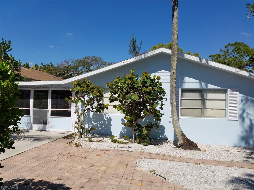 1009 Ridge Street Naples, FL 34103 - Photo 2 of 10 a front view of a house with a yard and garage