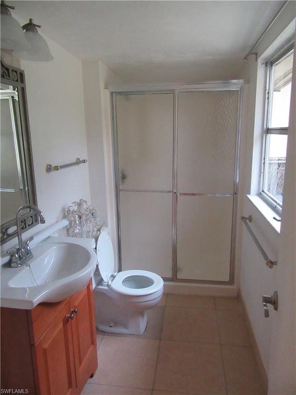 1009 Ridge Street Naples, FL 34103 - Photo 8 of 10 a bathroom with a sink and a toilet
