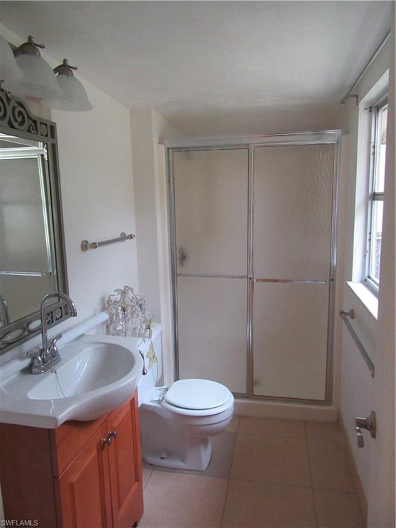 1009 Ridge Street Naples, FL 34103 - Photo 9 of 10 a bathroom with a sink toilet vanity and shower