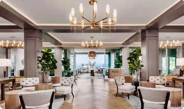a living room with lots of furniture chandelier and a chandelier