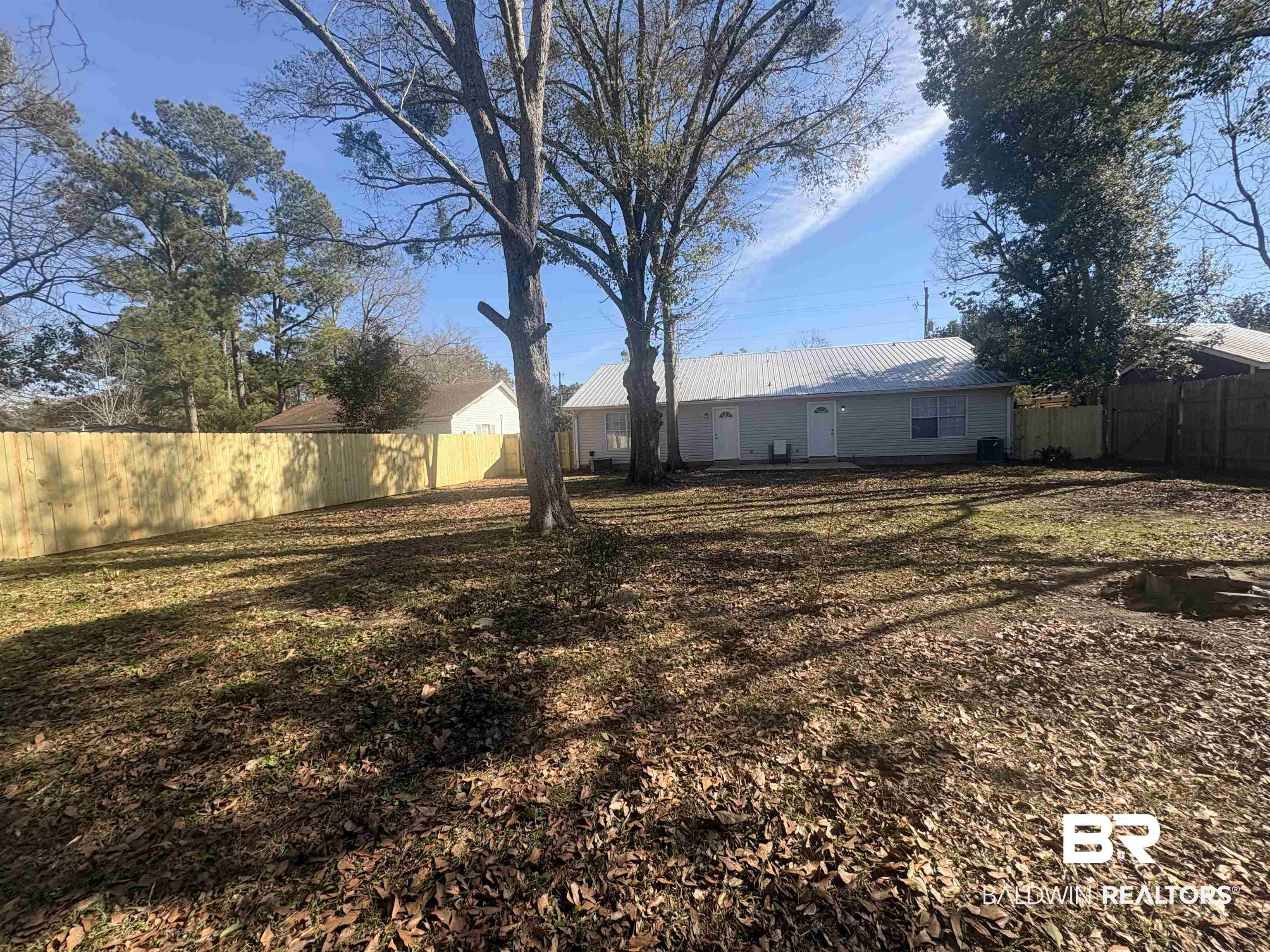 109-111 North Beech Street, Unit A & B Foley, AL 36535 - Photo 13 of 16 Back of house with a metal roof