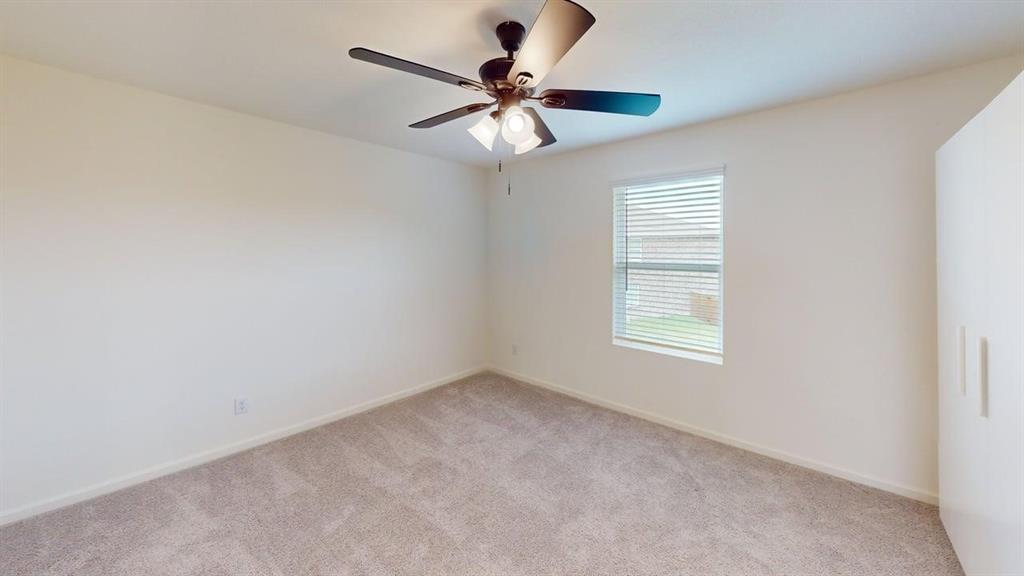 4529 Winecup Road Melissa, TX 75454 - Photo 18 of 29 Spacious room featuring neutral carpeting, light-colored walls, and a ceiling fan with integrated lighting