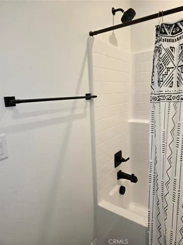 a bathroom with a shower and a glass door