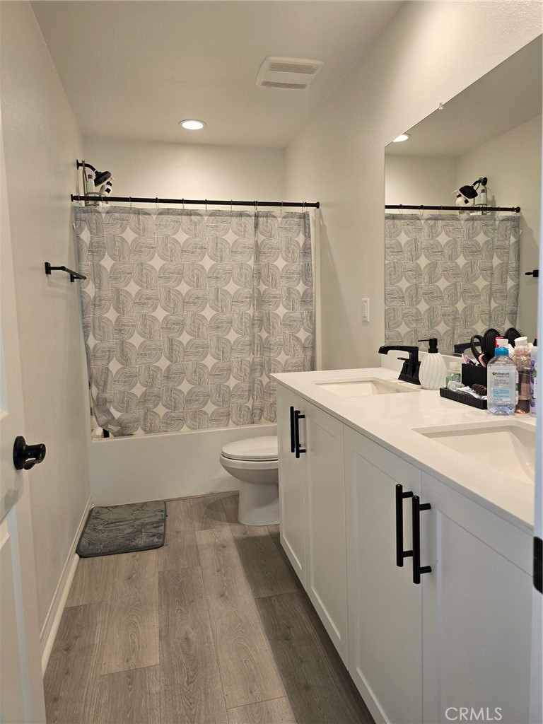 14196 Hercules Street Hesperia, CA 92345 - Photo 18 of 21 a bathroom with a double vanity sink toilet and shower