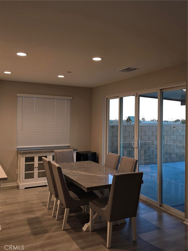 14196 Hercules Street Hesperia, CA 92345 - Photo 4 of 21 a view of a dining room with furniture window and wooden floor
